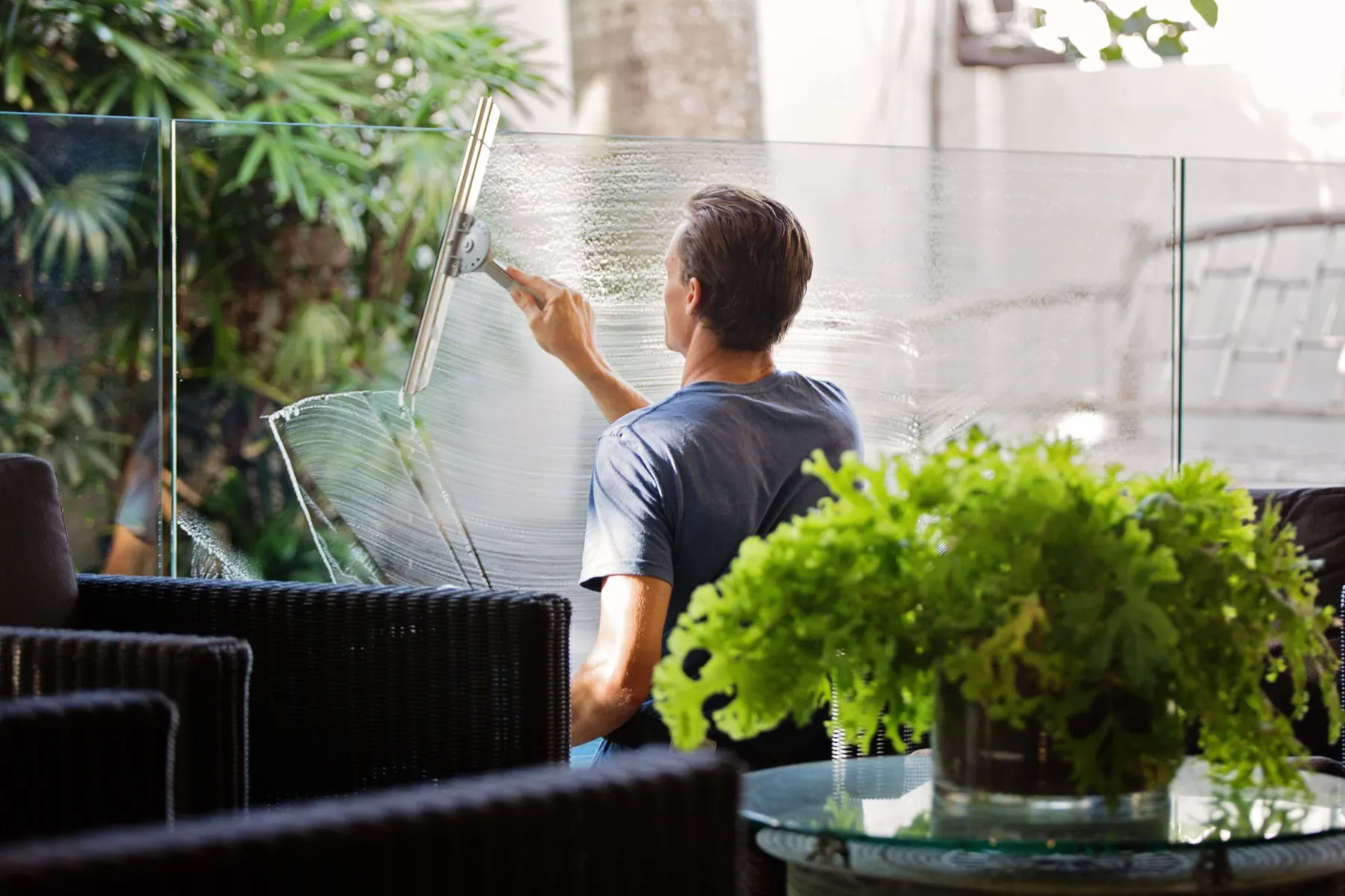 Cleaning a glass panel with a squeegee